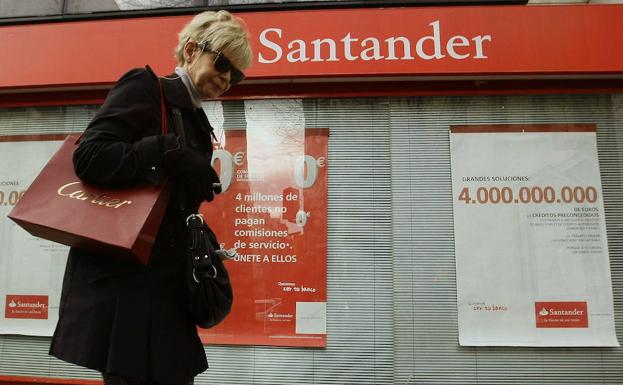 Una mujer pasa por delante de una sucursal del Banco Santander
