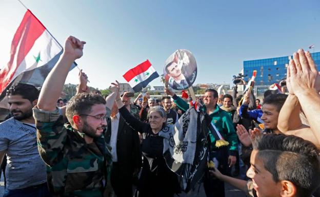 Ciudadanos salen a la calle en apoyo a Bashar al-Assad./Afp
