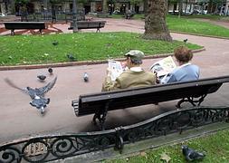 Dos ancianos leen el periódico en Jardines de Albia. / Luis Ángel Gómez | Atlas/