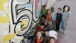 Un grupo de alumnos posa junto al graffiti realizado con motivo del 50 aniversario del colegio logroñés./ RAFAEL LAFUENTE Imágenes de las alumnas que estrenaron las aulas del colegio Vélez de Guevara en el año 1958. / E. C./